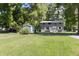 Charming two-story home with light blue front door, white shutters, lush lawn, and mature trees at 11170 Sw 190Th Ave, Dunnellon, FL 34432