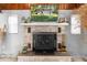 Cozy fireplace with brick surround, wood mantel and rustic decor at 11170 Sw 190Th Ave, Dunnellon, FL 34432