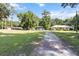 Sprawling front yard with mature trees and a long driveway leading to the house at 11170 Sw 190Th Ave, Dunnellon, FL 34432