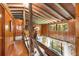 Spacious living room with wood accents, a natural wood banister, and ample natural light at 11170 Sw 190Th Ave, Dunnellon, FL 34432