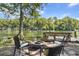 Cozy waterfront spot featuring a fire pit, bench, and comfortable chairs ideal for enjoying scenic views at 11170 Sw 190Th Ave, Dunnellon, FL 34432