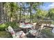 Inviting outdoor seating area with a stone table and four chairs, perfect for relaxing by the waterfront at 11170 Sw 190Th Ave, Dunnellon, FL 34432