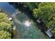Aerial view of a serene river with docks and recreational activities at 11170 Sw 190Th Ave, Dunnellon, FL 34432