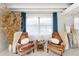 Cozy sitting area featuring two armchairs, a window, and light colored walls at 11170 Sw 190Th Ave, Dunnellon, FL 34432