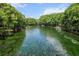 Scenic waterfront view featuring clear water and lush greenery, perfect for kayaking and enjoying nature at 11170 Sw 190Th Ave, Dunnellon, FL 34432