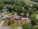 Elevated view of a home featuring solar panels, a metal roof, a large yard, and mature trees in a quiet neighborhood at 1601 Ne 47Th Ct, Ocala, FL 34470