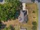 Overhead view of a home with solar panels and a metal roof, surrounded by mature trees on a corner lot at 1601 Ne 47Th Ct, Ocala, FL 34470