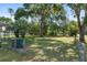 Large backyard featuring a mix of grass, mature trees, and privacy fencing at 1601 Ne 47Th Ct, Ocala, FL 34470