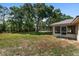 Spacious backyard with an awning, large trees, and lush grass at 1601 Ne 47Th Ct, Ocala, FL 34470