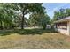 Large backyard with mature trees providing ample shade at 1601 Ne 47Th Ct, Ocala, FL 34470