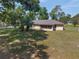 Aerial view showcases backyard with mature trees and a screened-in porch at 1601 Ne 47Th Ct, Ocala, FL 34470