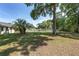 Wide shot of the backyard with large trees, open sky, and an awning at 1601 Ne 47Th Ct, Ocala, FL 34470