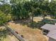 Aerial view of a large fenced backyard with mature trees providing shade and seclusion at 1601 Ne 47Th Ct, Ocala, FL 34470