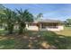 Backyard featuring an outdoor living space and tropical landscaping at 1601 Ne 47Th Ct, Ocala, FL 34470