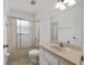 Bathroom with a shower and bathtub combination, toilet, and light tan vanity at 1601 Ne 47Th Ct, Ocala, FL 34470