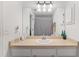 Bathroom with a large mirror, light tan countertops, and white cabinets at 1601 Ne 47Th Ct, Ocala, FL 34470