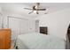 Bright bedroom with a ceiling fan, dresser, and a bed with a light blue bedspread at 1601 Ne 47Th Ct, Ocala, FL 34470