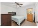 Cozy bedroom with a bed, window with blinds, ceiling fan, and dresser at 1601 Ne 47Th Ct, Ocala, FL 34470