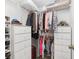 Organized walk-in closet featuring shelving and hanging storage for clothes and accessories at 1601 Ne 47Th Ct, Ocala, FL 34470