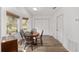Cozy dining area with a round table set, wood floors, and natural light from the windows at 1601 Ne 47Th Ct, Ocala, FL 34470
