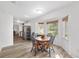 Bright dining area featuring a round table, wood floors, and sunlit windows at 1601 Ne 47Th Ct, Ocala, FL 34470