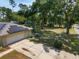 Home exterior featuring solar panels, a two-car garage, and a spacious, fenced backyard with mature trees at 1601 Ne 47Th Ct, Ocala, FL 34470