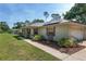 Charming home with a cozy front porch, manicured landscaping, and an attached garage at 1601 Ne 47Th Ct, Ocala, FL 34470