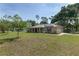 Charming home with solar panels, a metal roof, a well-manicured lawn, and a cozy front porch with rocking chairs at 1601 Ne 47Th Ct, Ocala, FL 34470