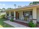 Inviting front porch with rocking chairs and tasteful decor enhances the curb appeal of this lovely home at 1601 Ne 47Th Ct, Ocala, FL 34470