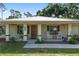Charming front porch featuring rocking chairs and tasteful decor that enhances the curb appeal of this lovely home at 1601 Ne 47Th Ct, Ocala, FL 34470