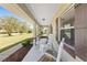 Inviting front porch showcasing rocking chairs, adding to the home's charm and creating a welcoming entrance at 1601 Ne 47Th Ct, Ocala, FL 34470