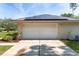 Attached garage showcasing a clean, white door with solar panels visible above at 1601 Ne 47Th Ct, Ocala, FL 34470