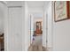 Hallway with wood-look floors, a closet, and an entryway leading to an office space at 1601 Ne 47Th Ct, Ocala, FL 34470