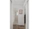 Hallway with wood-look floors, leading to a bathroom and other rooms in the home at 1601 Ne 47Th Ct, Ocala, FL 34470