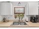 Charming kitchen sink with stained-glass window and stylish fixtures at 1601 Ne 47Th Ct, Ocala, FL 34470