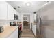 Bright kitchen featuring stainless steel appliances, wooden floors, and white cabinets at 1601 Ne 47Th Ct, Ocala, FL 34470