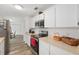 Bright kitchen with white cabinets, stainless steel appliances, and modern wood-look flooring at 1601 Ne 47Th Ct, Ocala, FL 34470