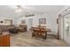 Open-concept living area featuring wood-look flooring, neutral walls, and a cozy dining area at 1601 Ne 47Th Ct, Ocala, FL 34470