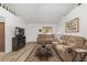 Inviting living room with wood-look floors, tan couches, and natural light from the front door at 1601 Ne 47Th Ct, Ocala, FL 34470