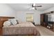 Spacious main bedroom featuring a ceiling fan, a large TV and a window with natural light at 1601 Ne 47Th Ct, Ocala, FL 34470