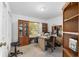 Office with a large wooden desk, bookshelves, cabinets, and a window at 1601 Ne 47Th Ct, Ocala, FL 34470