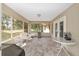 View of screened in porch with outdoor kitchen, fireplace, and plenty of room for entertaining at 1601 Ne 47Th Ct, Ocala, FL 34470