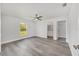 Bright bedroom features a ceiling fan, light gray flooring, ensuite bathroom, and walk-in closet at 16697 Sw 30 Avenue Rd, Ocala, FL 34473