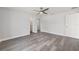 Bright bedroom with light gray floors, ceiling fan, and white trim, offering a clean and modern look at 16697 Sw 30 Avenue Rd, Ocala, FL 34473