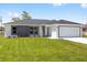 Charming single-story home featuring a gray accent wall and a well-manicured lawn at 16697 Sw 30 Avenue Rd, Ocala, FL 34473