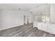 Open-concept kitchen with bar island, white cabinets, and stylish flooring at 16697 Sw 30 Avenue Rd, Ocala, FL 34473