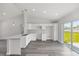 Well-lit kitchen with white cabinets and light gray countertop with stainless faucet, flowing into dining area at 16697 Sw 30 Avenue Rd, Ocala, FL 34473