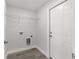Bright laundry room with wire shelving, updated flooring and convenient hookups at 16697 Sw 30 Avenue Rd, Ocala, FL 34473