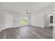 Open-concept living room featuring lots of natural light and gray laminate floors at 16697 Sw 30 Avenue Rd, Ocala, FL 34473