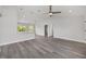 Open-concept living space with pendant lights, vaulted ceiling, and gray wood-look floors at 16697 Sw 30 Avenue Rd, Ocala, FL 34473